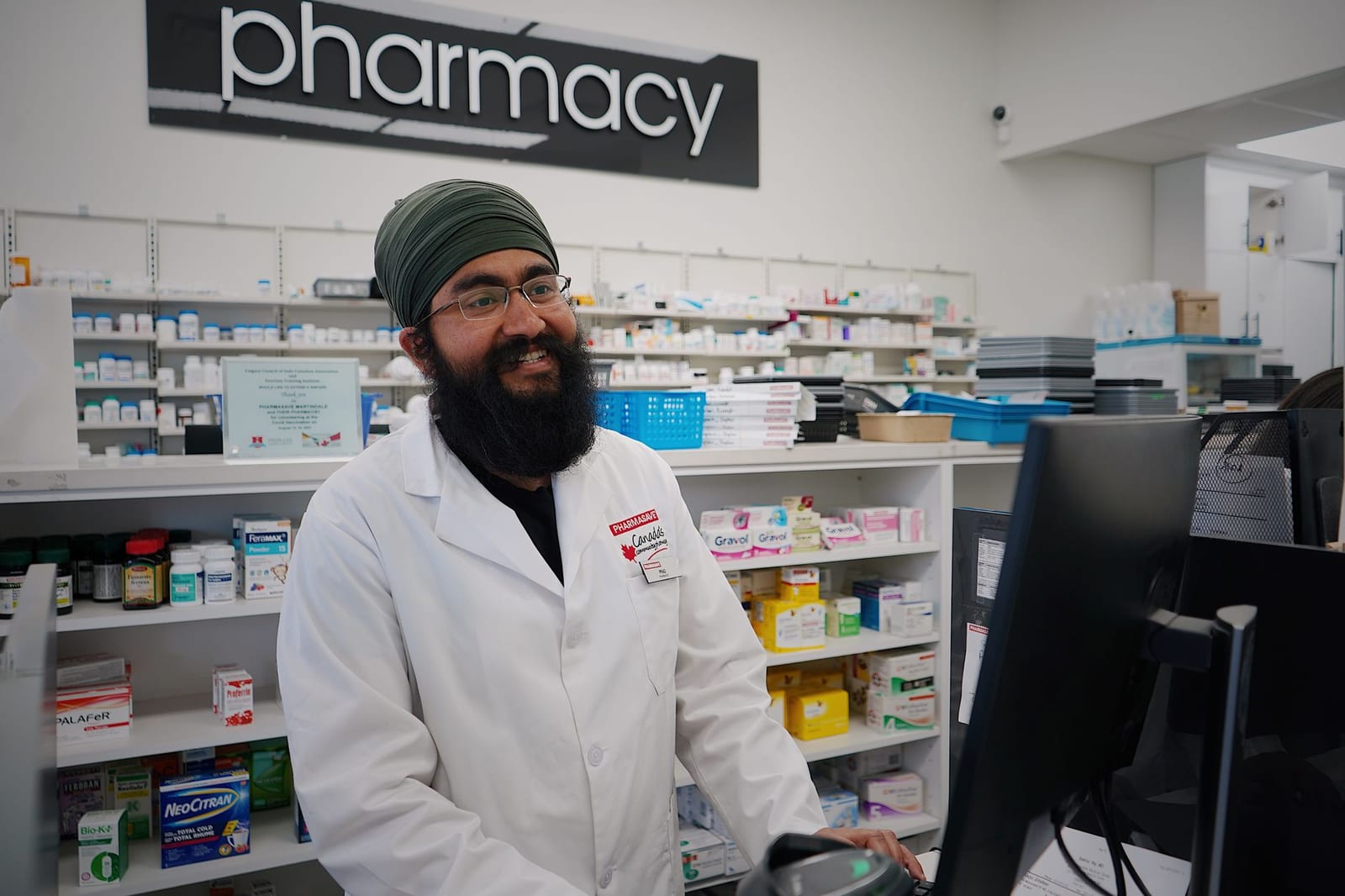 A community pharmacist at work behind the pharmacy counter